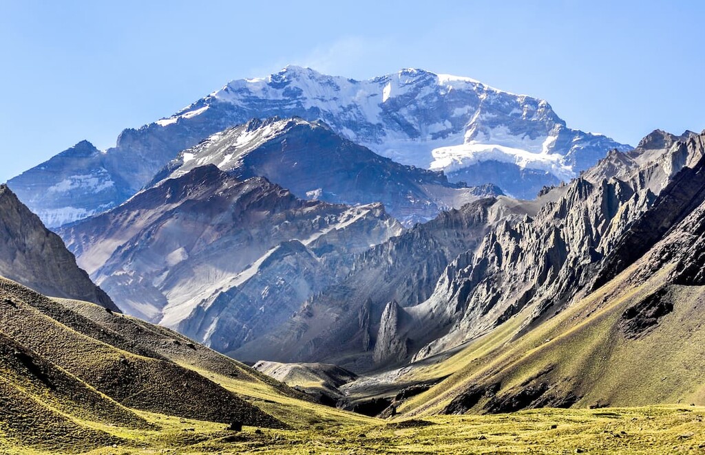 Trekkers hiking near snowy Andean peaks